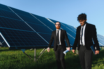 Investors walking and discussing about solar panel farm investment