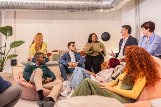 Coworkers playing with a ball during a break in the office