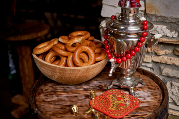 Wedding decoration in the Slavic style. A samovar with red beads and a doll. The art of tea drinking
