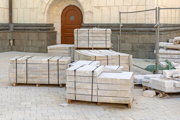 Pallets of Stacked White Marble Tiles at Construction Site
