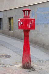 Obsolete Retro Red Post Phone Communication Firefighters at Street in City Centre