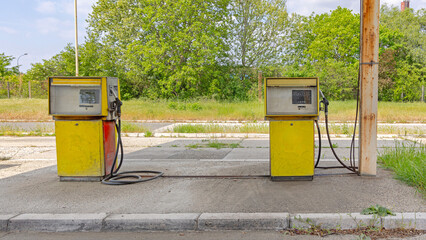 Two Yellow Diesel Pump Gas Oil at Old Fueling Station Rural Road Sunny Day