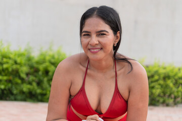 Latin woman smiling and practicing pilates outdoors