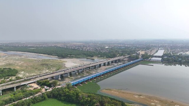 An Aerial Shot of Delhi Metro at Kalindi Kunj Bridge in Delhi, NCR, India
