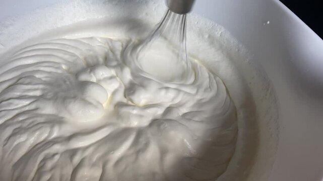 Quick & Easy See how quickly and easily cream is whipped to light, airy peaks. Great for baking tips, recipe videos, or sweet treat visuals.