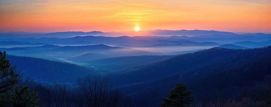 Sunrise over misty mountain range. Scenic vista. Wallpaper - Powered by Adobe