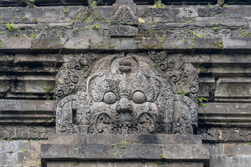 View of protector Kala face stone carving on lintel of ancient hindu Singhasari aka Singosari...