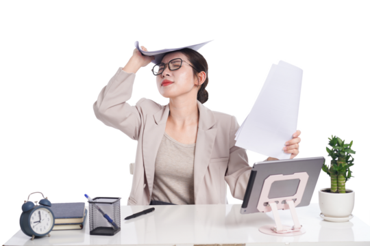 Asian businesswoman posing next to desk full of documents