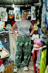 A girl stands in the market in Thai pants