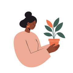 Black woman with hair in a bun in a gentle mood holding a potted plant against a white background with copy space.