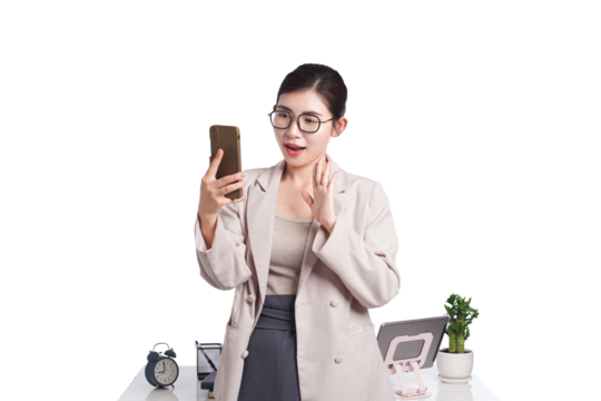 Asian businesswoman posing with smartphone, behind her is a table with lots of documents