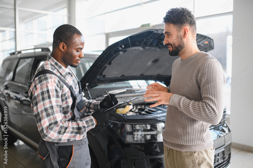 Aufkleber man on the result of the work of a mechanic. the client evaluates the repair of the car by a mechani