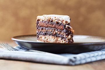 Piece of chocolate cake on rustic background. Close up.	