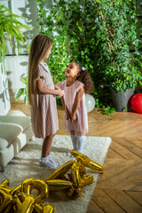 girls, Sisters joyfully embracing each other in a lush and cozy living space filled with warmth