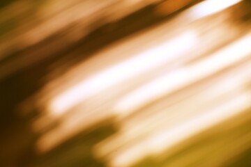 Abstract golden light streaks flowing across a darkened space