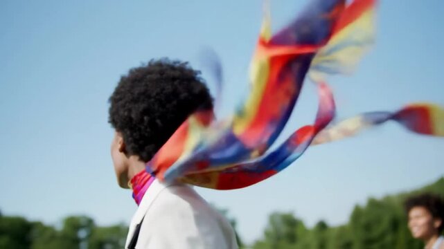 someone walks with a colored scarf blowing in the wind