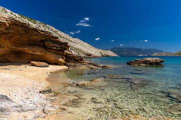 Panorama of the bay with the Vela Luka beach below, view of the beach from the top of the mountain, rocky beach
