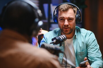 Podcast presenter having live discussion with man, streaming it for audience on internet...