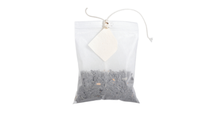 Tea bag filled with loose leaf tea and tied with natural twine, close-up of organic herbal infusion in rustic packaging, eco-friendly teabag isolated on transparent background