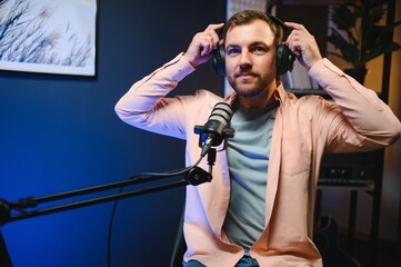 Man smiling while recording podcast in studio