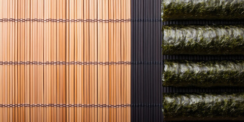 Bamboo mat lies next to stacked sheets of seaweed on a flat surface. Sushi preparation, Japanese cuisine