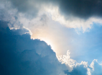 High-resolution image shows a blue sky filled with scattered white clouds. Natural light accentuates the soft texture of the clouds before a rain shower.