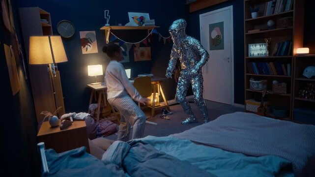 Full shot of funny alien monster teaching dancing movements to little Black girl having fun together in her cozy room in evening