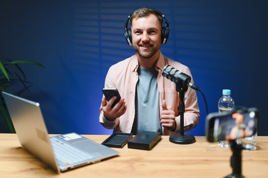 young adult man creating online content for the channel, daily vlog, unboxing a brand new phone at home, online sales