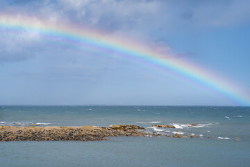 A colourful rainbow over the sea in Scotland