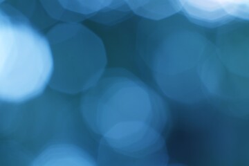 Abstract ethereal glowing light orbs on a cool blue green background