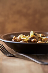 Onion with mushrooms. Rustic wooden background.	