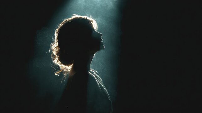 Profile of a young woman illuminated by a dramatic, cinematic light beam, creating a silhouette against a dark background, symbolizing hope, revelation, or spiritual awakening