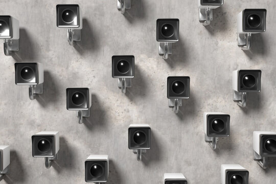 Security cameras observing on concrete wall