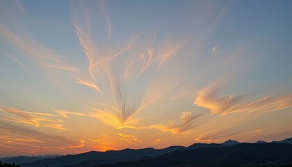 Naklejka premium sunset sky with dim sunlight casting warm tones over mountains, captured in sharp 4k resolution.
