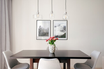 Modern dining area with minimalist decor and natural elements in a cozy apartment