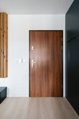 Naklejka na ściany i meble Modern wooden front door leading into an elegant residential hallway space