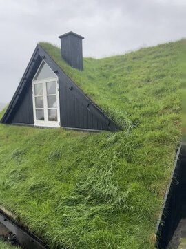 Travel to Saksun, Faroe Islands &mdash; a dreamy Nordic village with turf-roofed homes, coastal views, and misty weather. 