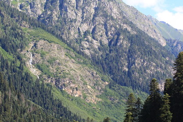 mountain peaks of elbrus region in dombai in midsummer