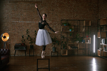 An elegant ballerina posing gracefully in a beautiful studio environment with style