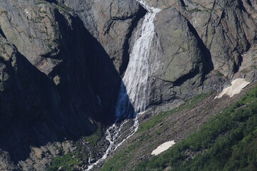Waterfalls from melting snow in the mountains of Elbrus region in Dombai