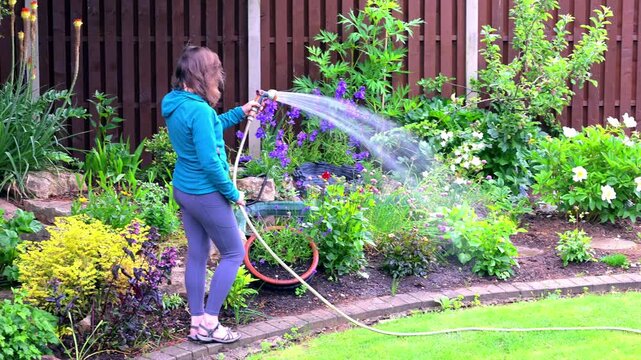 Woman watering flowers.