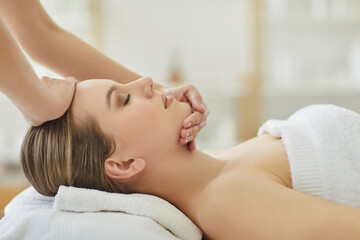 Obraz premium Dermatologist or cosmetologist provides facial massage to patient during skincare procedure in spa salon, focusing on treatment and care in a professional setting with relaxation and wellness.
