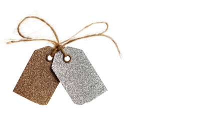 Two glittering gift tags, one gold and one silver, tied together with rustic twine, adding elegance and sparkle to gifts on a transparent background