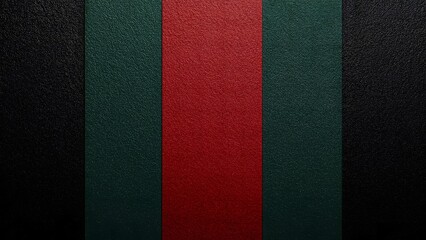 Fototapeta premium Close up textured surface with bold vertical stripes in black green and red leather like material rich in detail and depth
