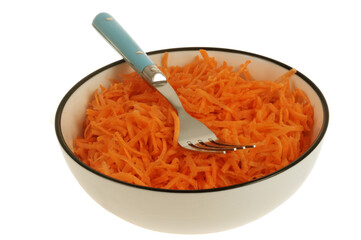 Assiette de carottes râpées avec une fourchette en gros plan isolée sur fond blanc