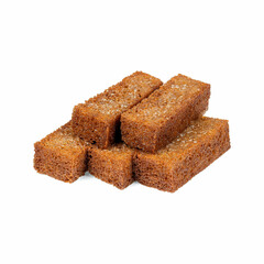 stack of five rectangular pieces of dark brown, crispy bread with a coarse texture and granules of salt or sugar sprinkled on top