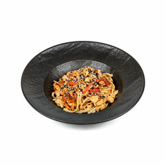 A black bowl filled with stir-fried noodles, chicken, bell peppers, and sesame seeds, presented on a white background