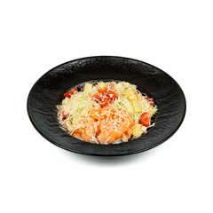 A black bowl filled with a fresh salad featuring smoked salmon, shredded cheese, diced tomatoes, lettuce, and croutons