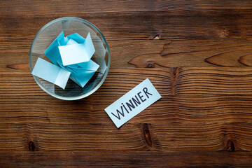 Winner on piece of paper in glass jar, top view. Luck and success concept.