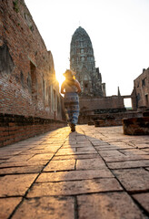 Rear view of young woman walking and exploring Ancient Ruins on holiday travel